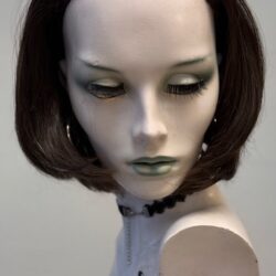 A mannequin with short hair and green eyes.