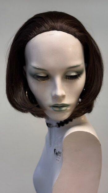 A mannequin with short hair and green eyes.