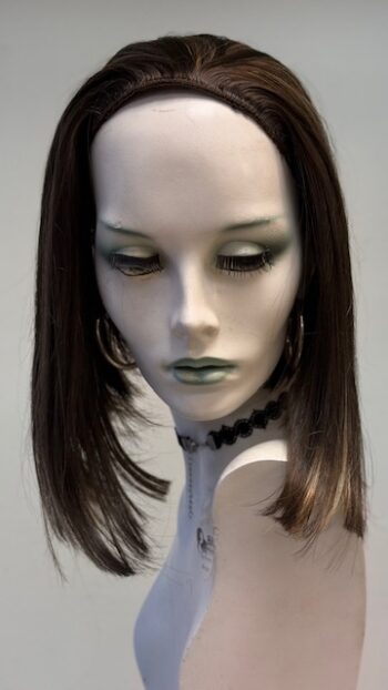 A mannequin with long hair and green eyes.