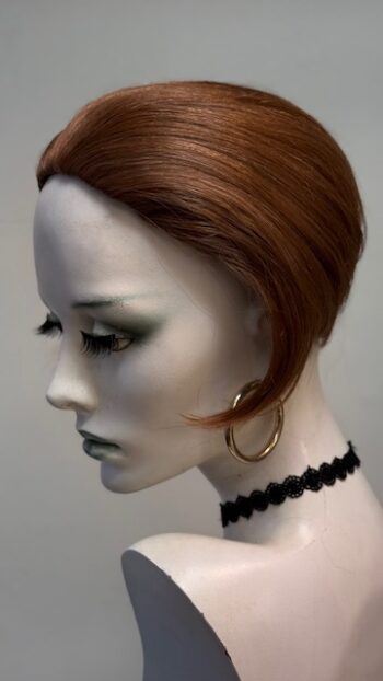 A mannequin head with black and white makeup on it.