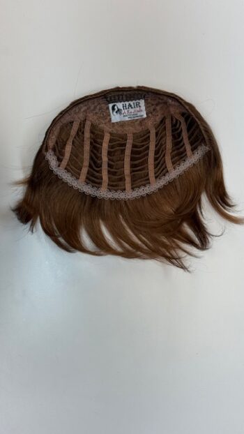 A brown wig with long hair on top of it.