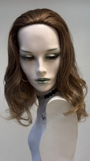 A mannequin with long hair and green eyes.