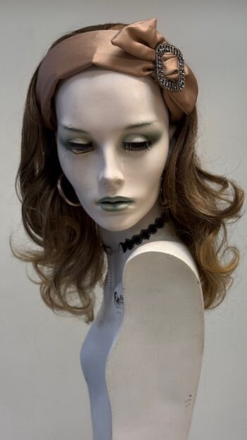 A mannequin with long hair and green eyes.