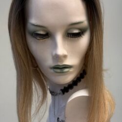 A mannequin with long blonde hair and green eyes.