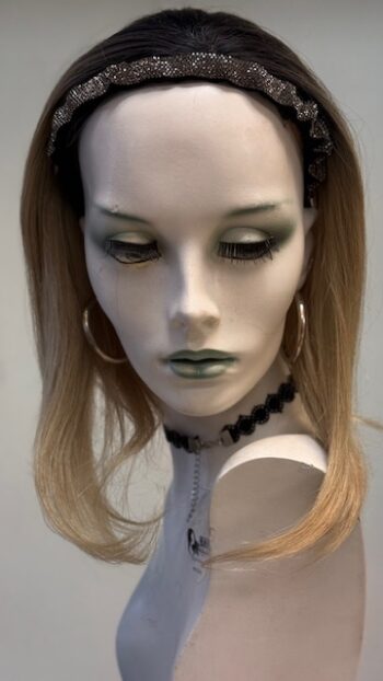 A mannequin with long blonde hair and green eyes.