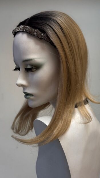 A mannequin with long blonde hair and green eyes.