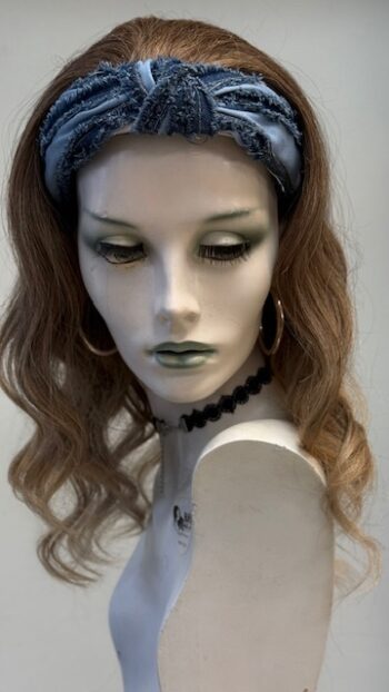 A mannequin with long hair and green eyes.