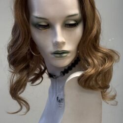 A mannequin with long hair and a neck tie.