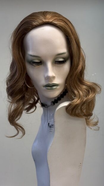 A mannequin with long hair and a neck tie.