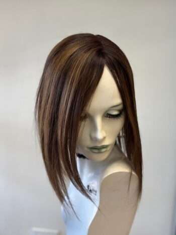 A mannequin head with long hair and a white shirt.