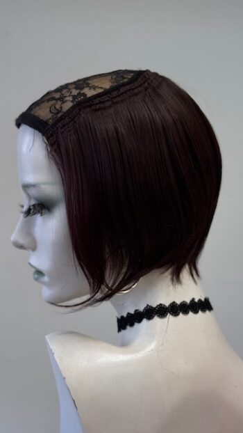 A mannequin with short hair and a lace headband.