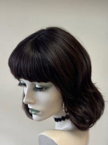 A mannequin head with bangs and black hair.