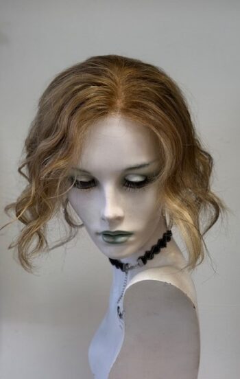 A mannequin with long blonde hair and green eyes.