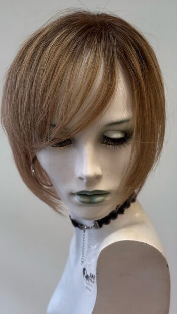 A mannequin head with short hair and black jewelry.