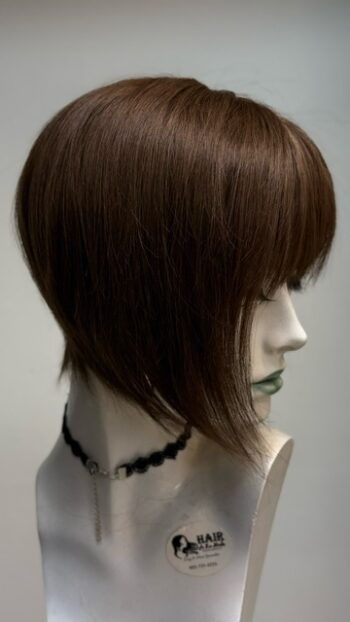 A mannequin head with a necklace on it