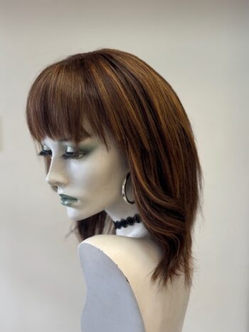 A mannequin with long hair and bangs on display.