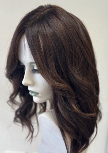 A mannequin head with long hair and brown highlights.