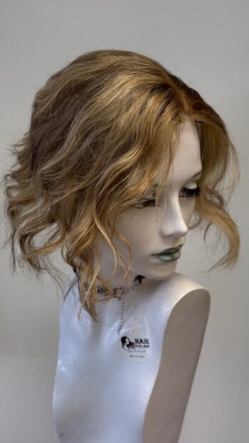 A mannequin with long hair and a necklace.