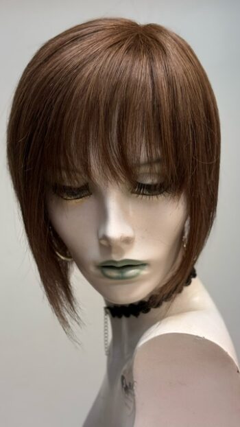 A mannequin with short hair and bangs.