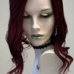 A mannequin with long red hair and green eyes.