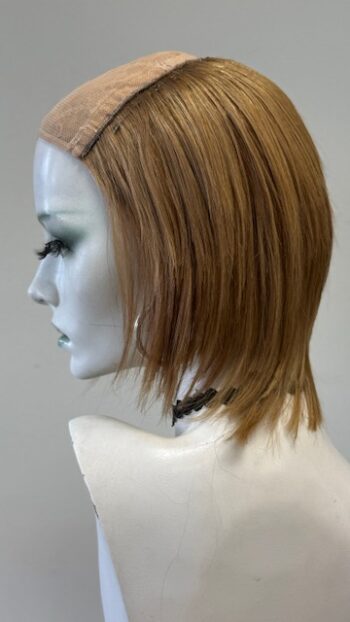 A mannequin head with a wig on it