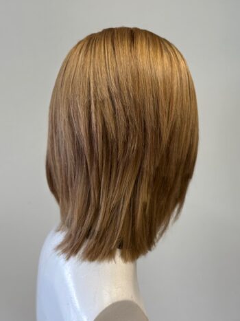 A woman 's head with long hair in front of a white background.