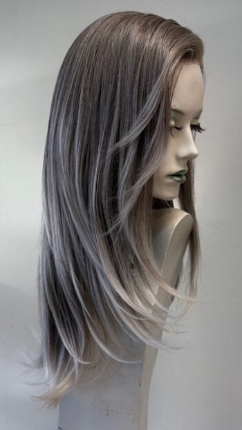 A mannequin with long grey hair and green eyes.