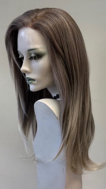 A mannequin with long hair and a green eye.