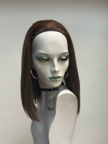 A mannequin with long hair and jewelry on display.