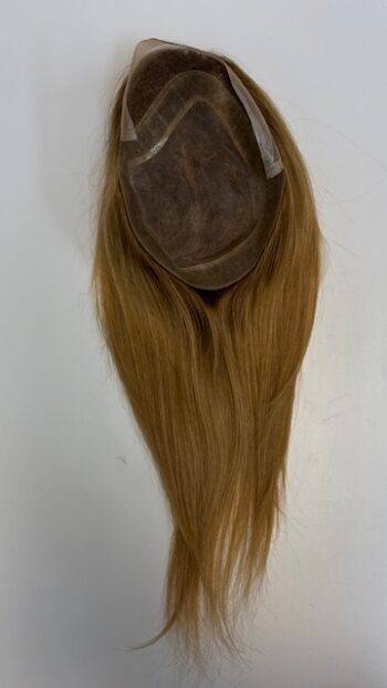 A long blonde wig hanging on the wall.