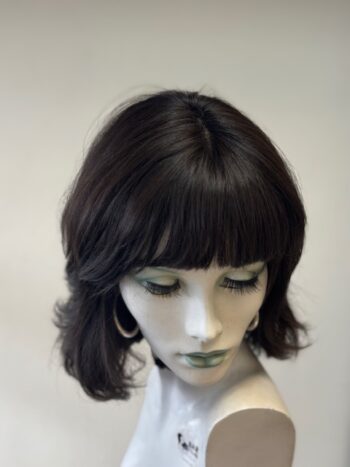 A mannequin with short hair and bangs.