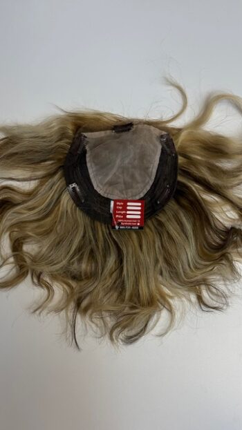 A wig with long hair is shown on the table.