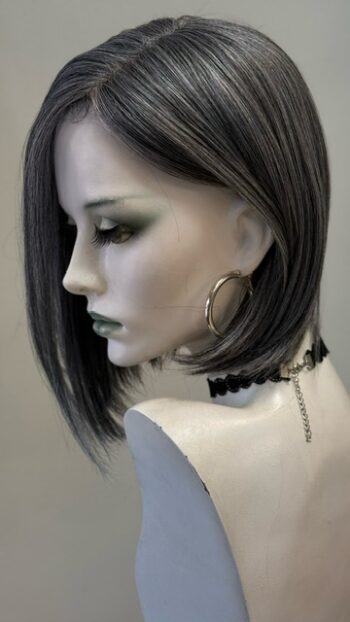 A mannequin with green eyes and black hair.