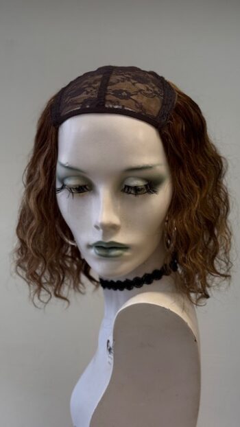 A mannequin with a wig and black lace headband.