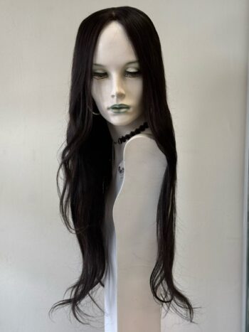 A mannequin with long black hair and green lipstick.