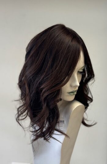 A mannequin with long dark hair and bangs.