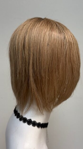 A blonde wig sitting on top of a white mannequin head.