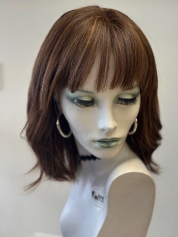 A mannequin with bangs and green eyes.