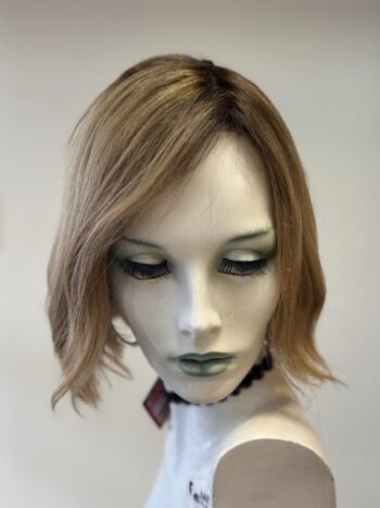 A mannequin with green eyes and blonde hair.