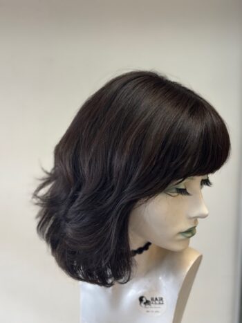 A mannequin wearing a wig with long hair.