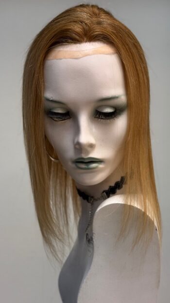 A mannequin with long hair and green eyes.