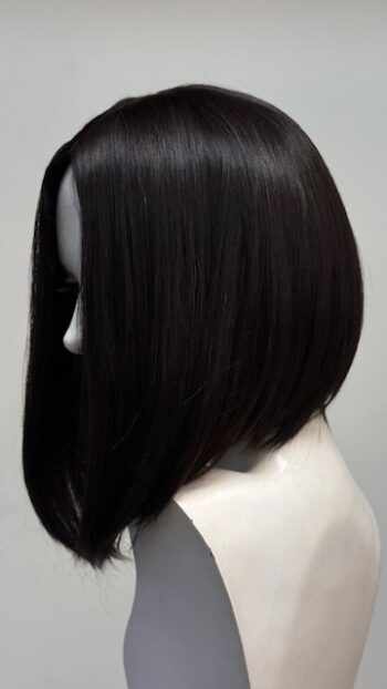 A black wig is on display in front of a white background.