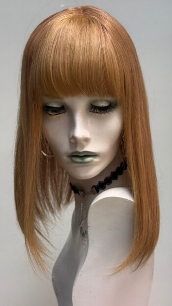 A mannequin with long red hair and green lipstick.