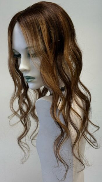 A mannequin head with long brown hair and bangs.