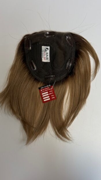 A hat with long hair hanging on the back of it.