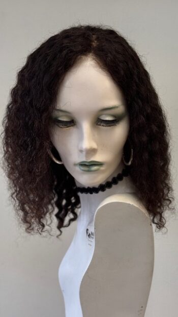 A mannequin with long black hair and green eyes.