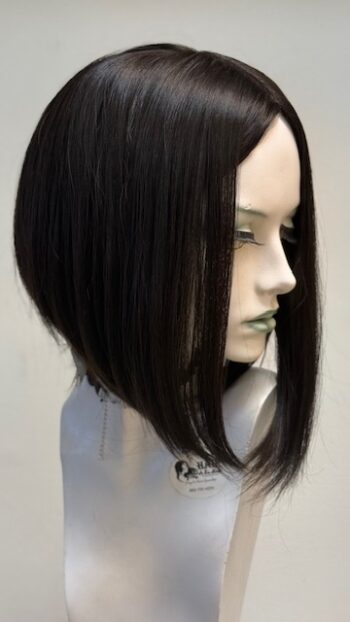 A mannequin with long black hair in front of a white background.