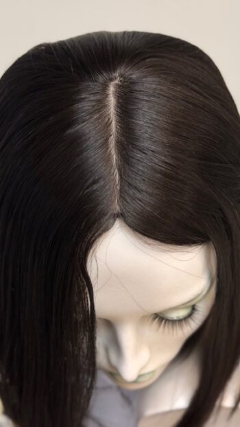 A close up of the front part of a woman 's head