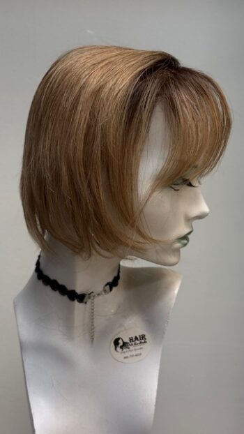 A mannequin head with a necklace and a wig.