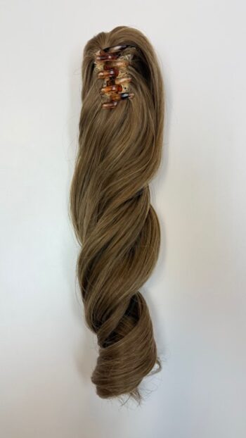 A long brown hair extension with some small pieces of gold.